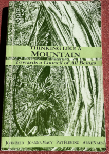 photo of book Thinking Like a Mountain: Towards a Council of All Beings with cover image of Rainforest abundance